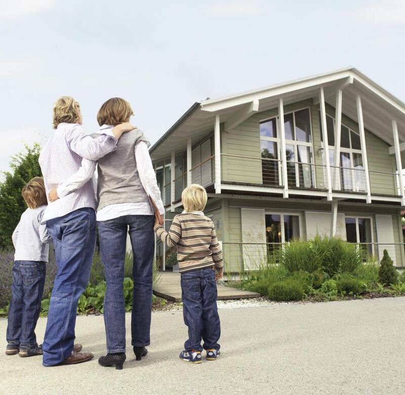 Family-standing-in-front-of-new-home.jpg